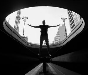 Preview wallpaper man, silhouette, bw, freedom, light, architecture