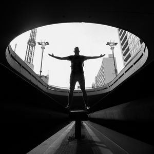 Preview wallpaper man, silhouette, bw, freedom, light, architecture