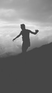 Preview wallpaper man, silhouette, clouds, mountains, bw