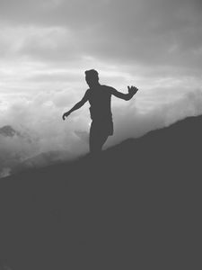Preview wallpaper man, silhouette, clouds, mountains, bw