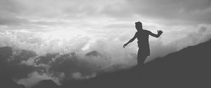 Preview wallpaper man, silhouette, clouds, mountains, bw