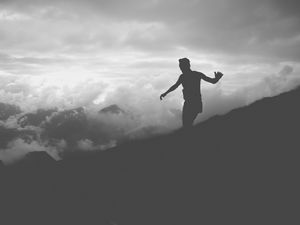 Preview wallpaper man, silhouette, clouds, mountains, bw