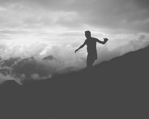 Preview wallpaper man, silhouette, clouds, mountains, bw