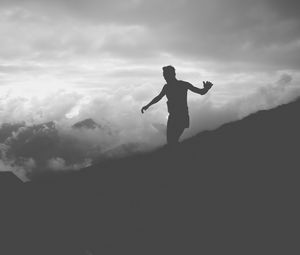 Preview wallpaper man, silhouette, clouds, mountains, bw