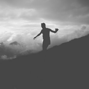 Preview wallpaper man, silhouette, clouds, mountains, bw