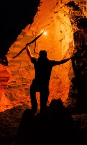 Preview wallpaper man, silhouette, fire, rocks