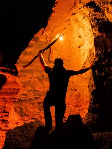 Preview wallpaper man, silhouette, fire, rocks