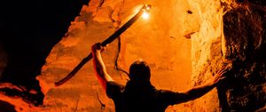 Preview wallpaper man, silhouette, fire, rocks