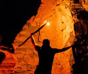Preview wallpaper man, silhouette, fire, rocks