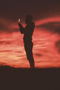 Preview wallpaper man, silhouette, fire, flame, dark