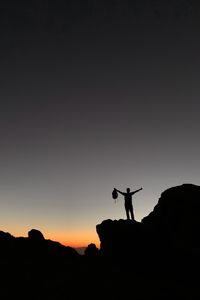 Preview wallpaper man, silhouette, freedom, loneliness, rocks, sunset