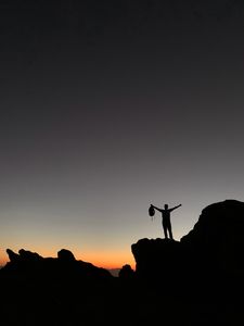 Preview wallpaper man, silhouette, freedom, loneliness, rocks, sunset