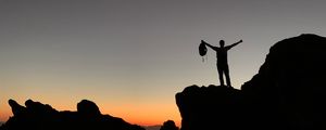 Preview wallpaper man, silhouette, freedom, loneliness, rocks, sunset