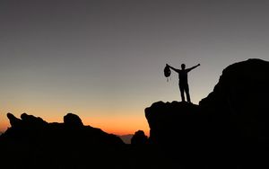 Preview wallpaper man, silhouette, freedom, loneliness, rocks, sunset