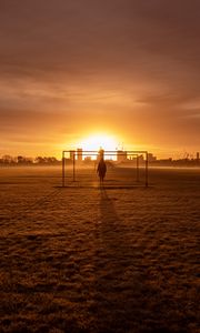 Preview wallpaper man, silhouette, gate, buildings, sunset