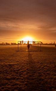 Preview wallpaper man, silhouette, gate, buildings, sunset