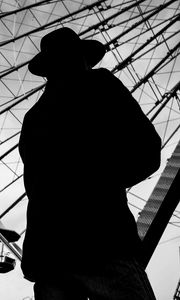 Preview wallpaper man, silhouette, hat, ferris wheel, alone, black and white