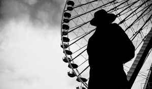 Preview wallpaper man, silhouette, hat, ferris wheel, alone, black and white