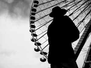 Preview wallpaper man, silhouette, hat, ferris wheel, alone, black and white