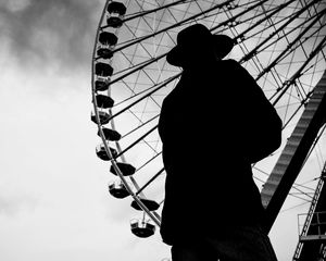 Preview wallpaper man, silhouette, hat, ferris wheel, alone, black and white