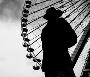 Preview wallpaper man, silhouette, hat, ferris wheel, alone, black and white