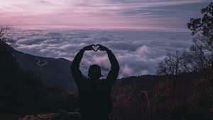 Preview wallpaper man, silhouette, heart, gesture, clouds, sunset
