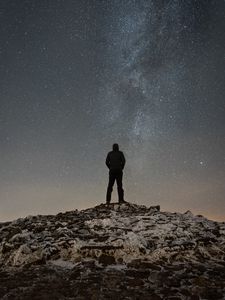 Preview wallpaper man, silhouette, hill, peak, starry sky