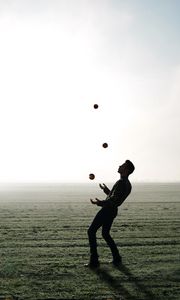 Preview wallpaper man, silhouette, juggling, field, fog