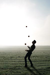 Preview wallpaper man, silhouette, juggling, field, fog