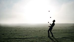 Preview wallpaper man, silhouette, juggling, field, fog