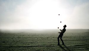 Preview wallpaper man, silhouette, juggling, field, fog