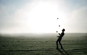 Preview wallpaper man, silhouette, juggling, field, fog