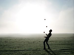 Preview wallpaper man, silhouette, juggling, field, fog