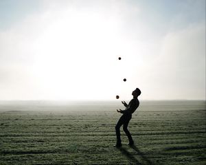 Preview wallpaper man, silhouette, juggling, field, fog