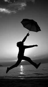 Preview wallpaper man, silhouette, jump, umbrella, black and white