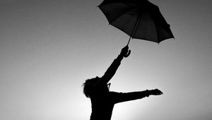 Preview wallpaper man, silhouette, jump, umbrella, black and white