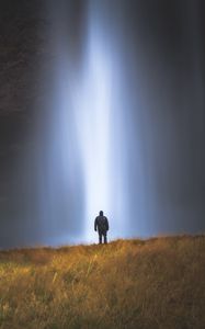 Preview wallpaper man, silhouette, light, grass, waterfall, alone