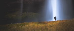 Preview wallpaper man, silhouette, light, grass, waterfall, alone