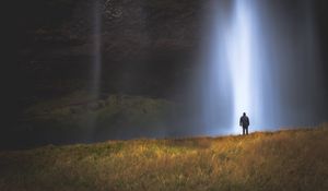 Preview wallpaper man, silhouette, light, grass, waterfall, alone