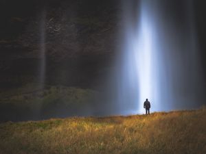 Preview wallpaper man, silhouette, light, grass, waterfall, alone