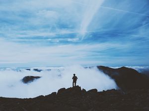 Preview wallpaper man, silhouette, mountains, clouds, top