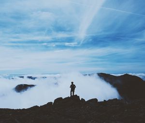 Preview wallpaper man, silhouette, mountains, clouds, top