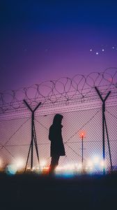 Preview wallpaper man, silhouette, night, barbed wire