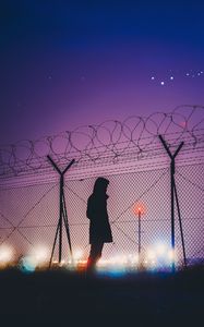 Preview wallpaper man, silhouette, night, barbed wire