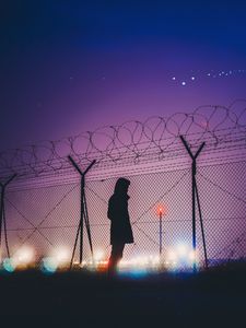 Preview wallpaper man, silhouette, night, barbed wire