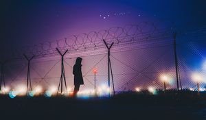 Preview wallpaper man, silhouette, night, barbed wire