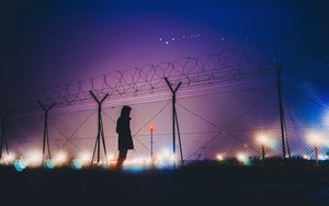 Preview wallpaper man, silhouette, night, barbed wire
