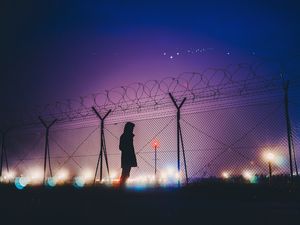 Preview wallpaper man, silhouette, night, barbed wire