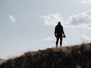 Preview wallpaper man, silhouette, photographer, hill, sky