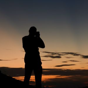 Preview wallpaper man, silhouette, photographer, sunset